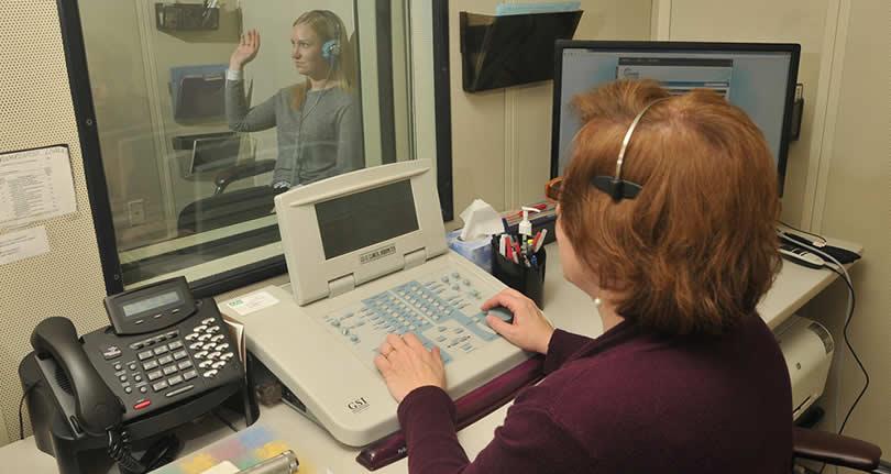 woman performing hearing test